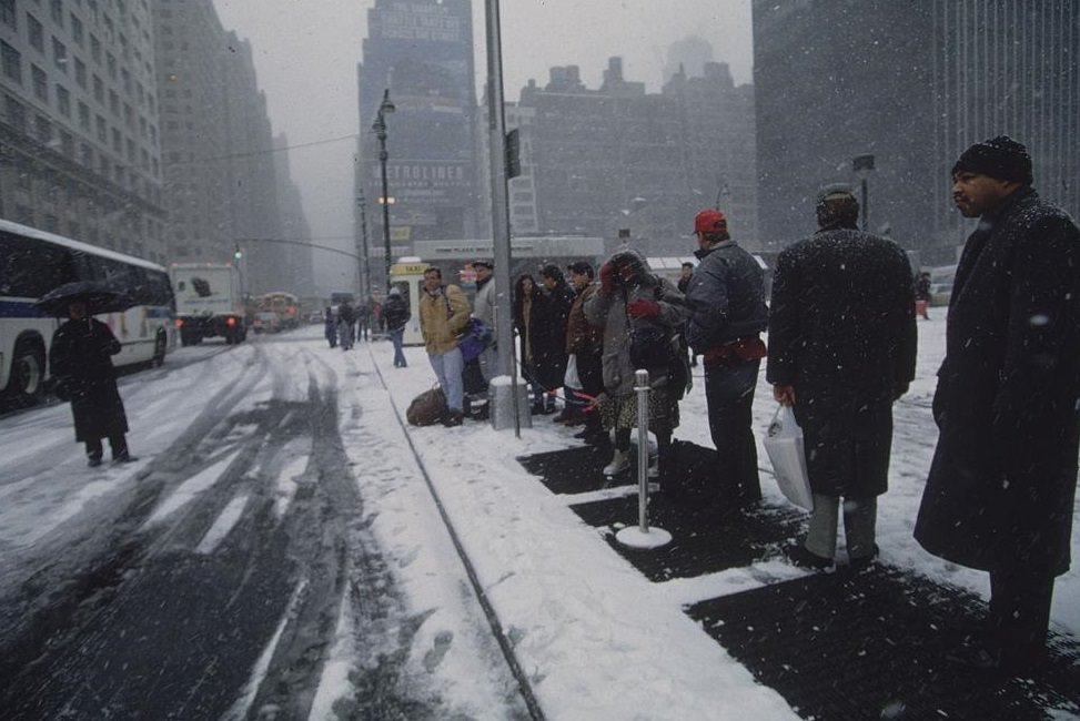 People Lining Up On Street At Bus Stop In Snow, 1996