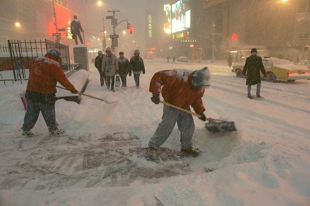 Workers Shovel Snow From The Sidewalk In Times Square, 1996