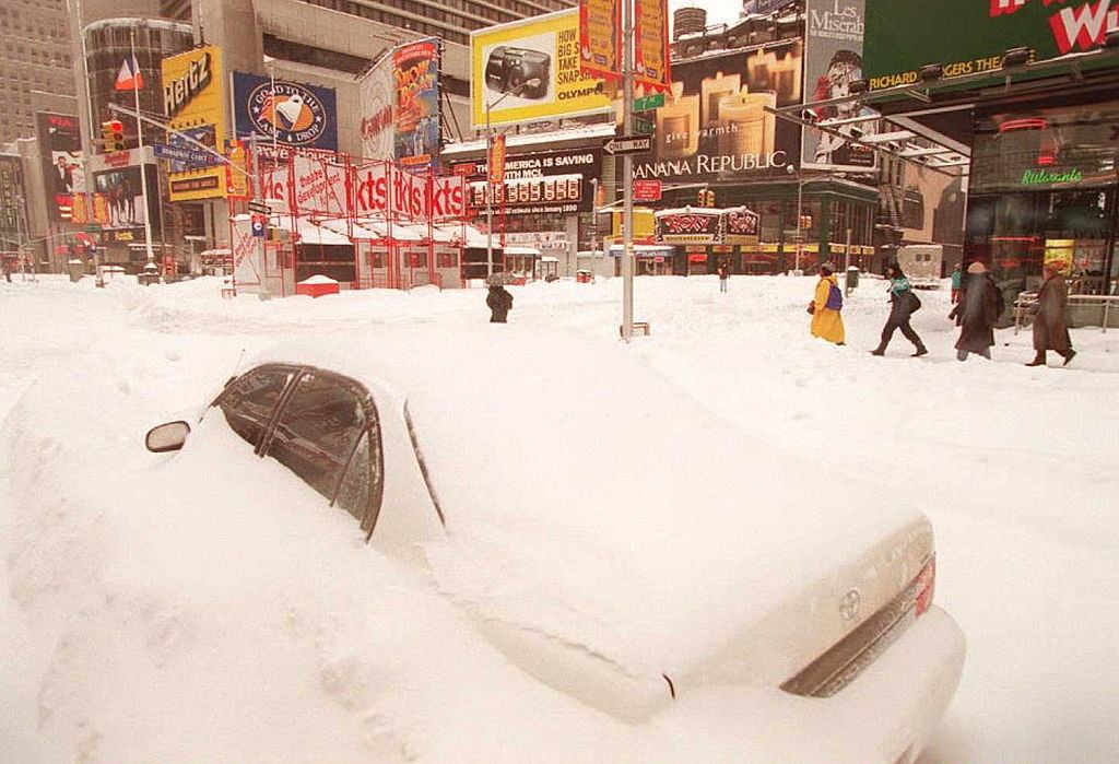 Pedestrians Make Their Way Past A Buried Car In New York'S Times Square, 1996