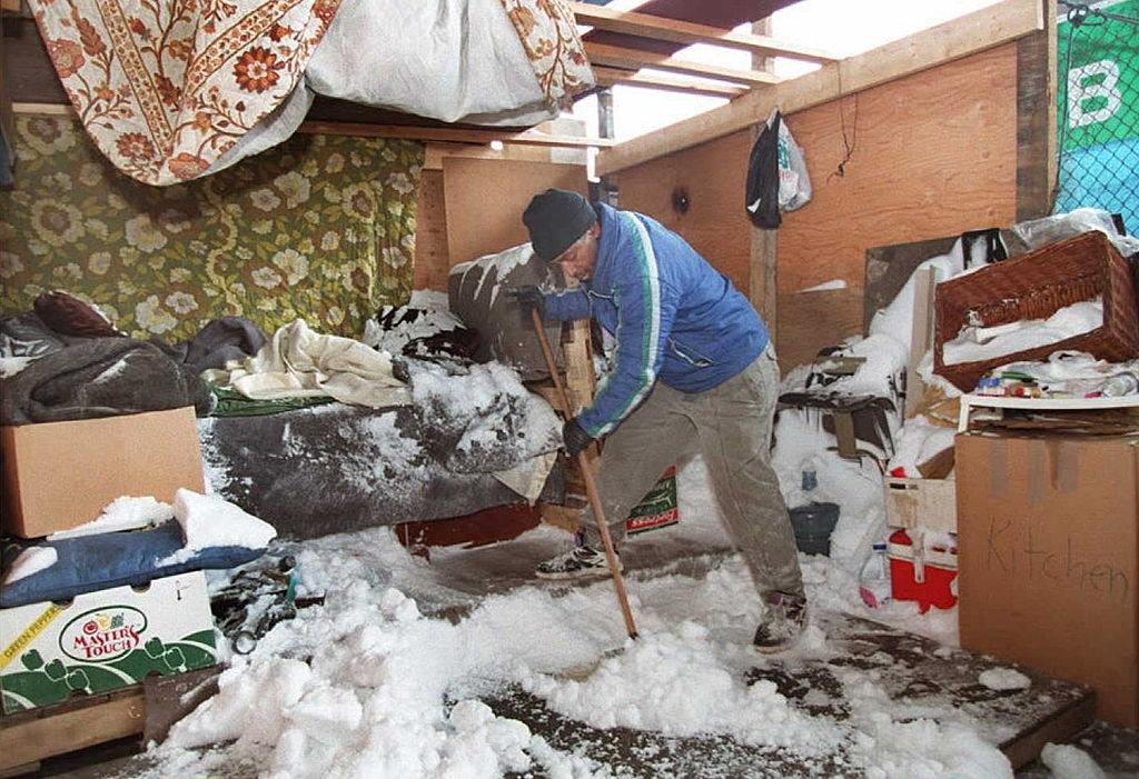 Ron Foster, 56, A Homeless Resident Of Sweeps Snow Out Of His Make-Shift Shelter On South Street In Manhattan, 1996