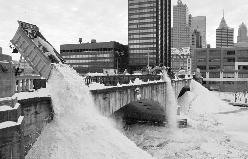 Trucks And A Payloader Dump Snow Into The Frozen Schuylkill River, As Philadelphia Tries To Dig Out From A Blizzard, 1996