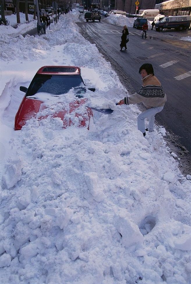 Woman Shoveling Snow Off Of Car, 1996