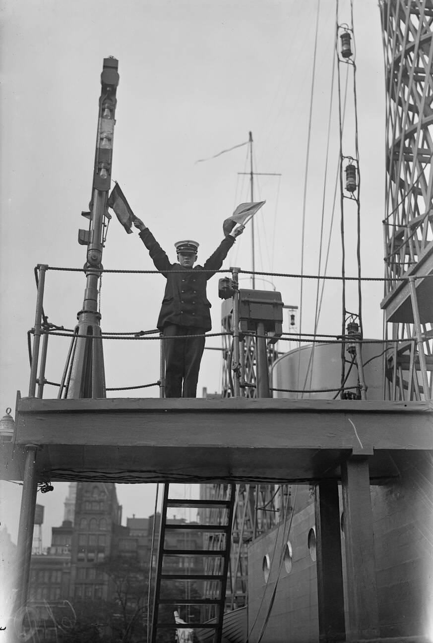 A Junior Naval Recruit Semaphore Flag Signaling On The Uss Recruit, 1917.