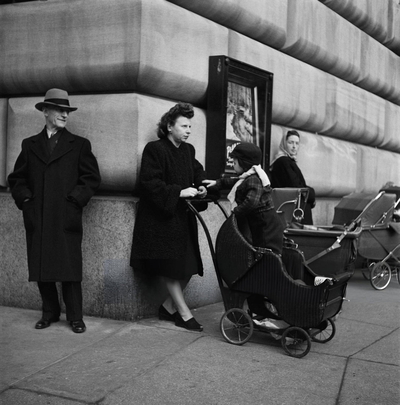 An Old Man Looks At A Child Who Stands Up In His Stroller On Broadway, 1947.