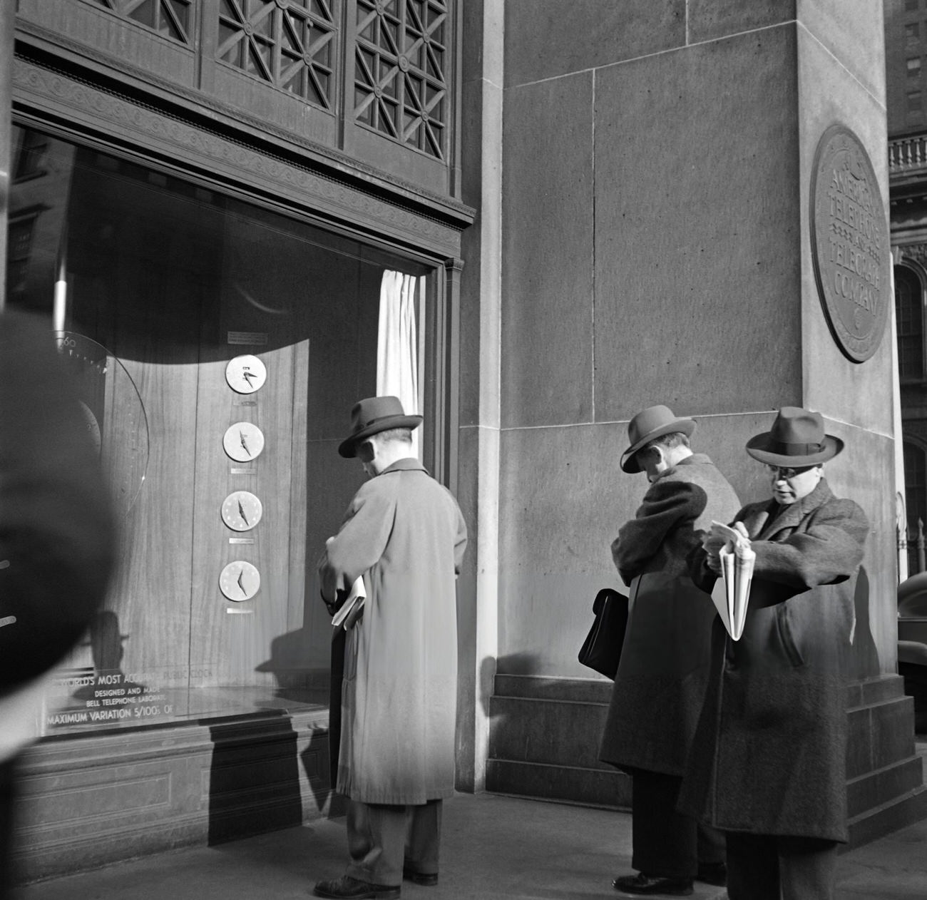 Businessmen Adjust Their Watches To The Clocks Displayed In The Telephone Building, 1947.