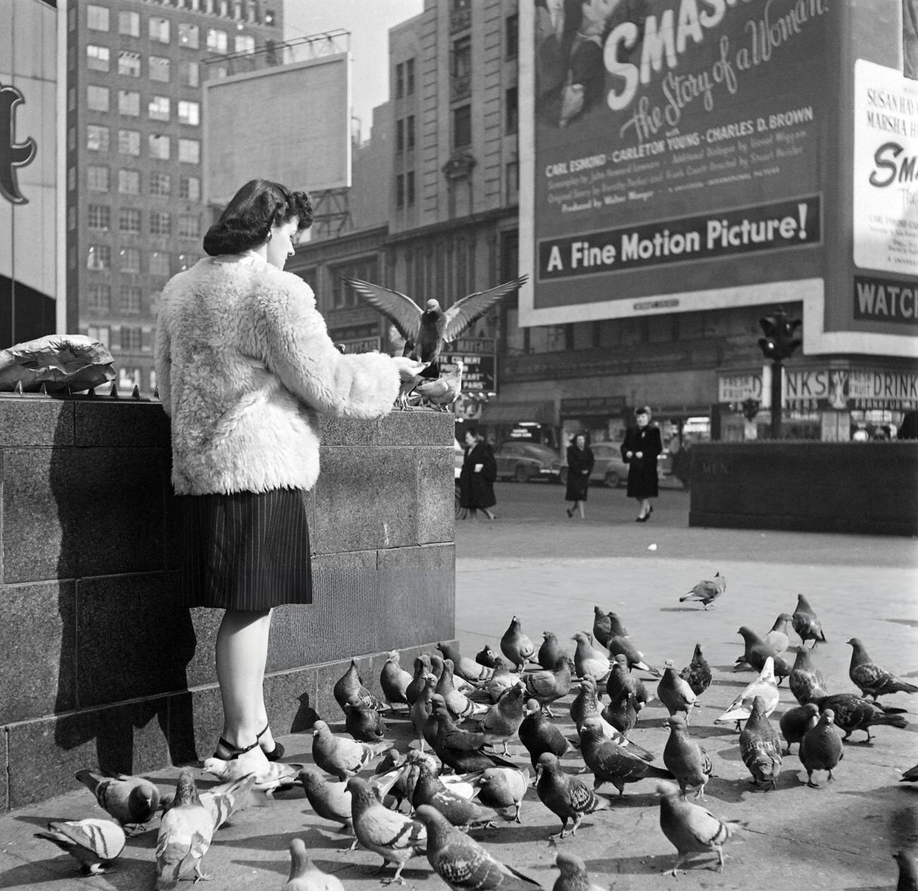 A Young Woman Feeds Pigeons On Broadway, 1947.