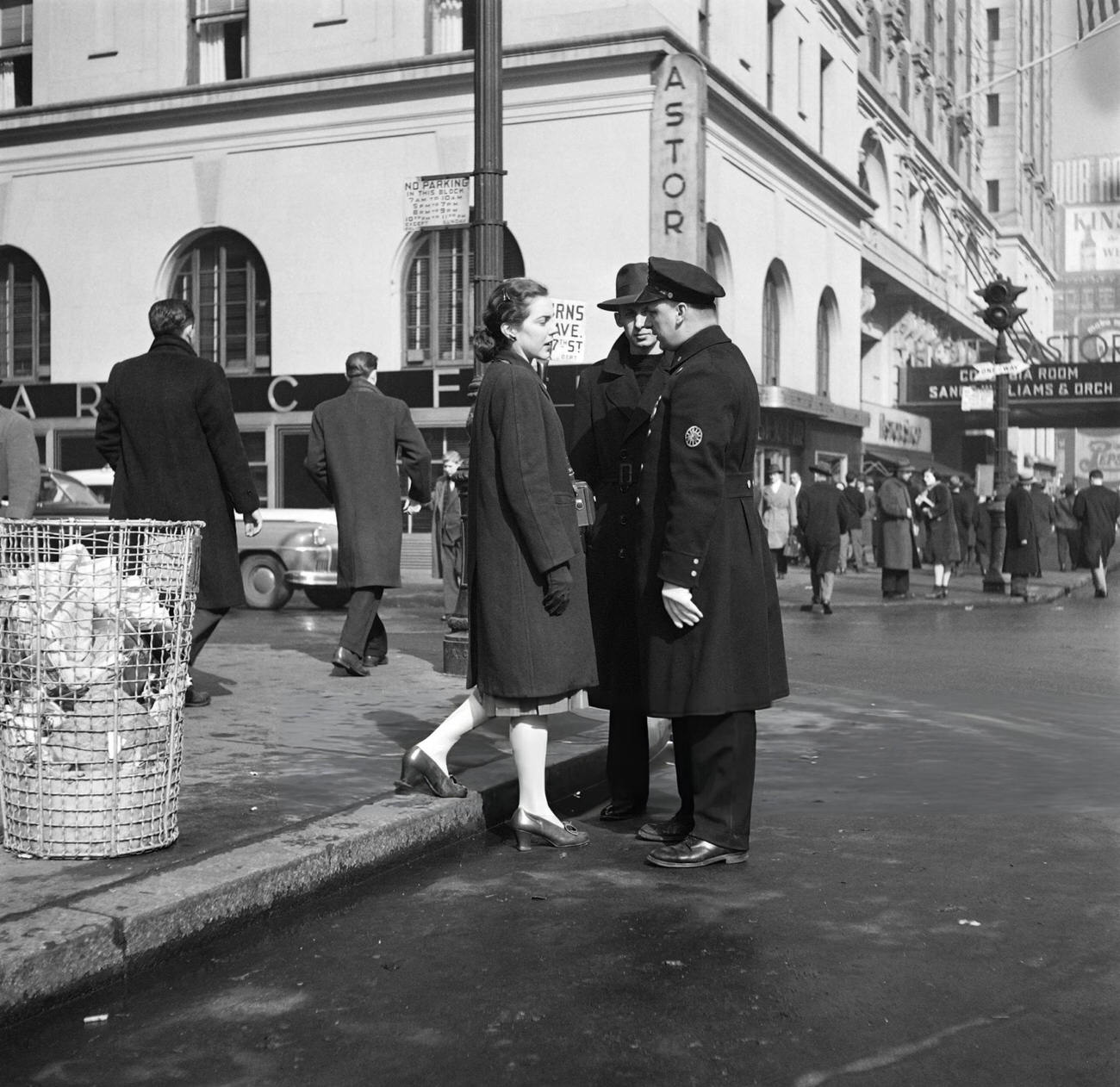 A Policeman Helps A Woman With A Camera Near The Hotel Astor, 1947.