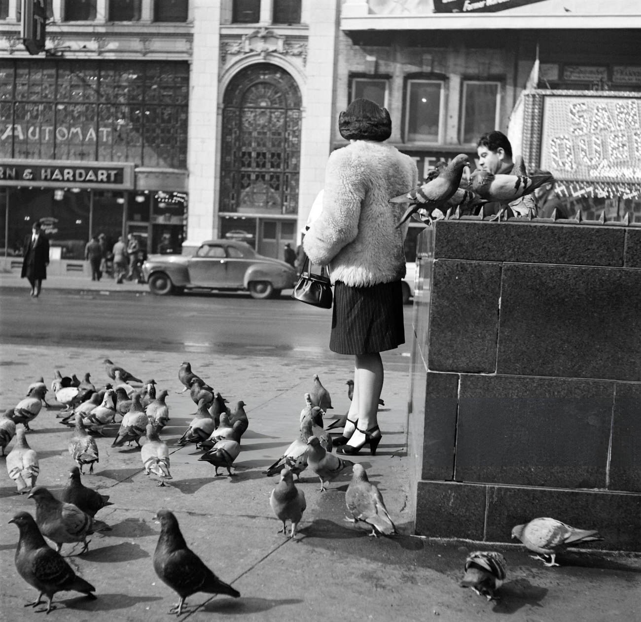 A Young Woman Feeds Pigeons Near A Horn And Hardart Automat Restaurant, 1947.