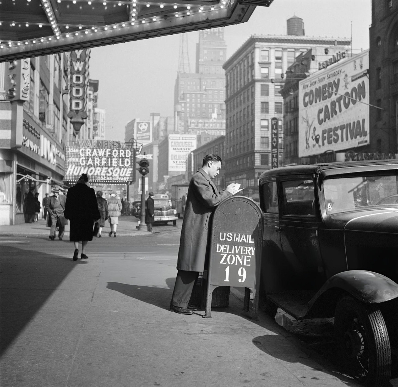 A Man Prepares Mail Before Putting It In A Mailbox In Front Of The Capitol Theater, 1947.