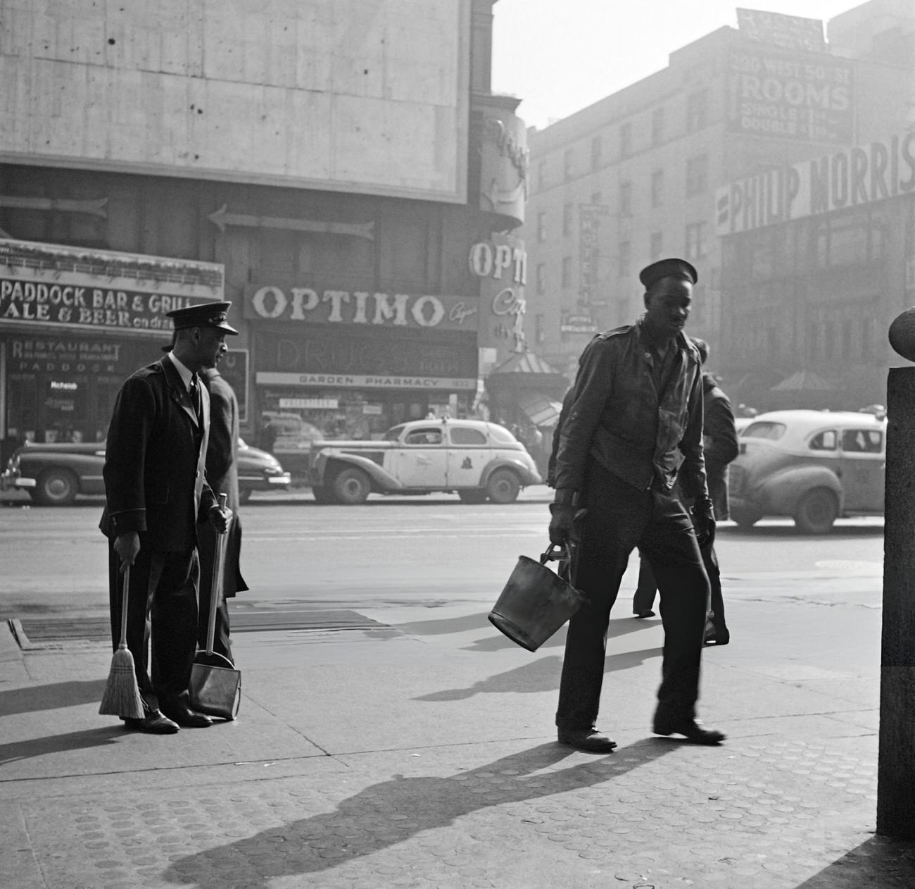 Two Afro-American City Workers Sweep A Sidewalk Of Broadway, 1947.