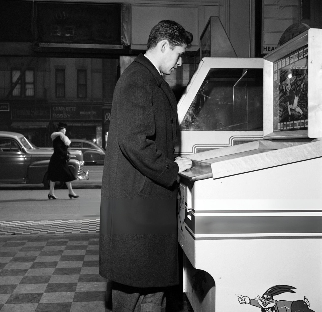 A Man Looks At A Juke-Box In A Bar On Broadway, 1947.