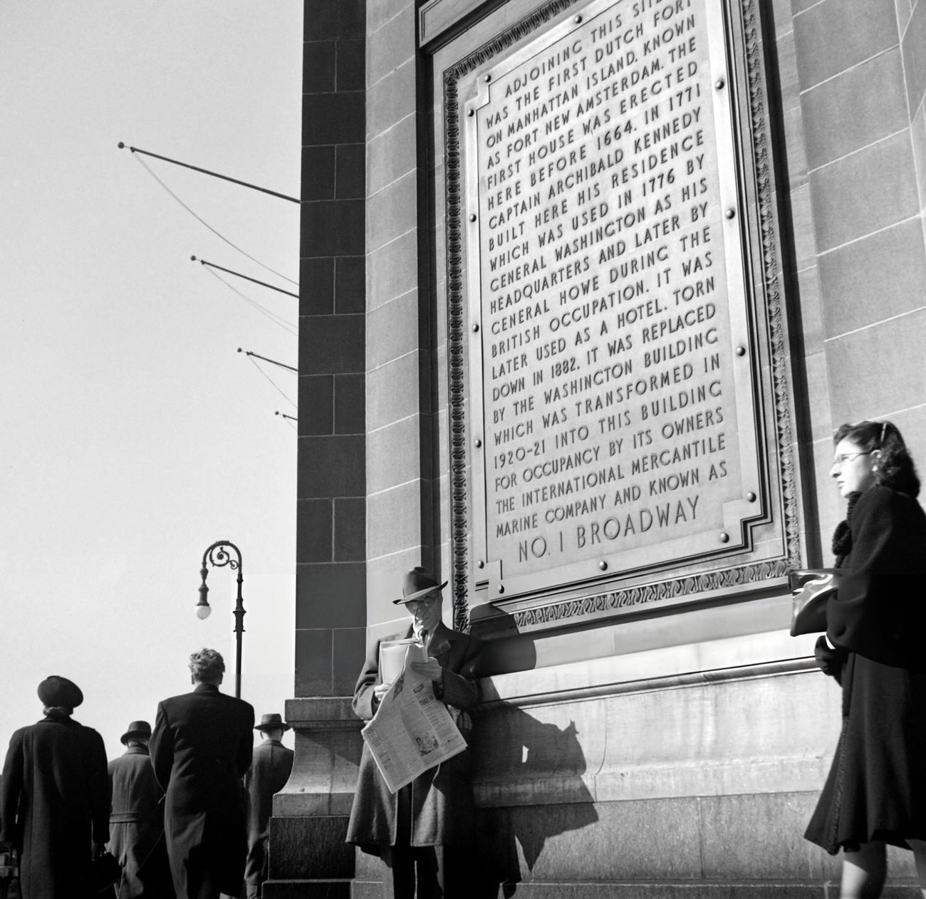 A Man Reads The New York Times Newspaper, Standing Against The Number One Broadway Building, 1947.