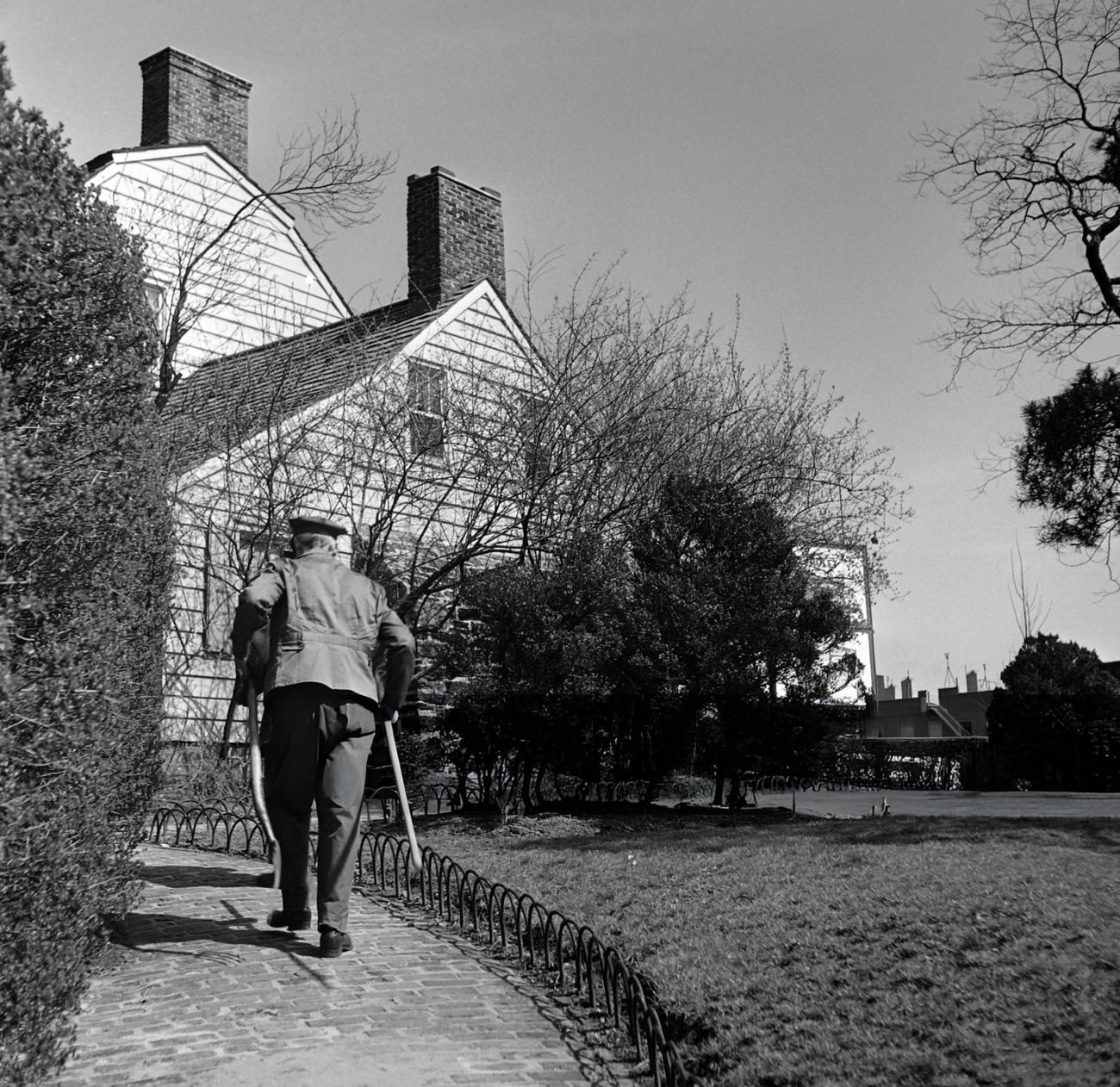 A Gardener Walks In The Garden Of The Dyckman Farmhouse, 1947.