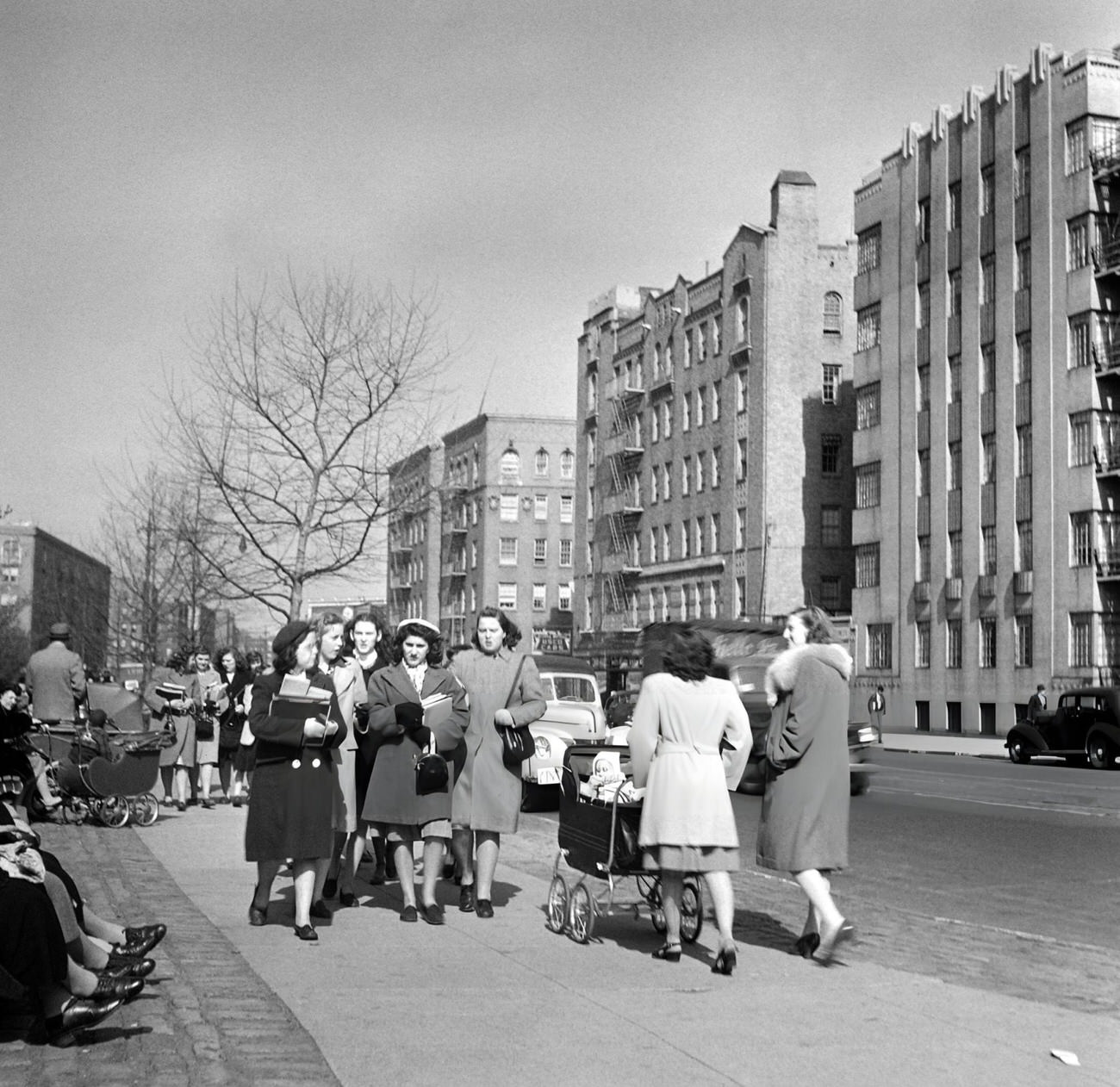 Women With A Baby Carriage Meet Students Coming The Other Way On A Sidewalk, 1947.