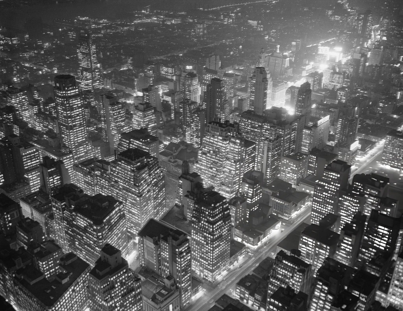 Office Buildings Brightly Lit Early In The Evening, With Times Square In The Background, 1940S.