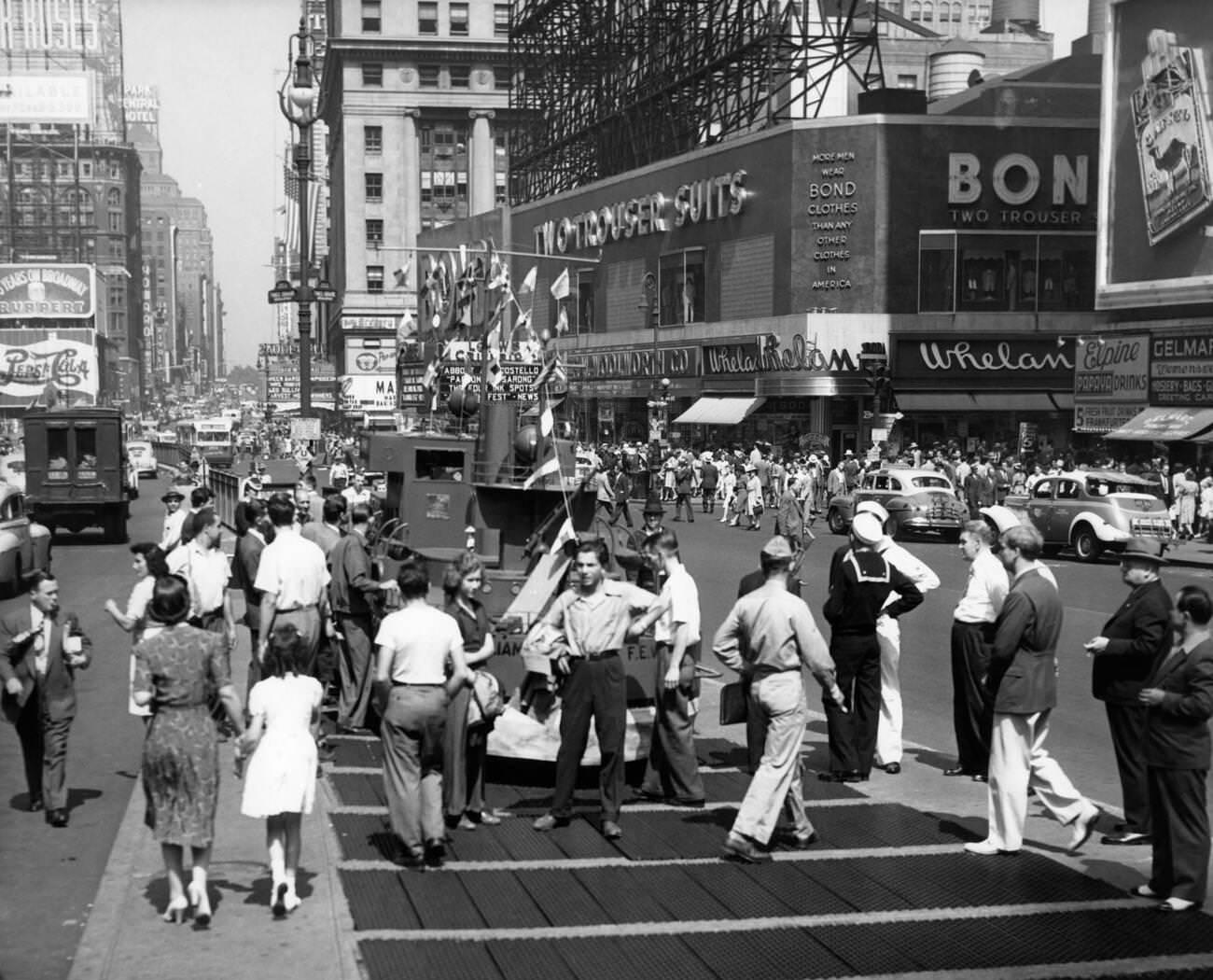 Pedestrians And Traffic In Times Square With Two Sailors Near A Model Of A Navy Ship, A Recruiting Station, 1940S.