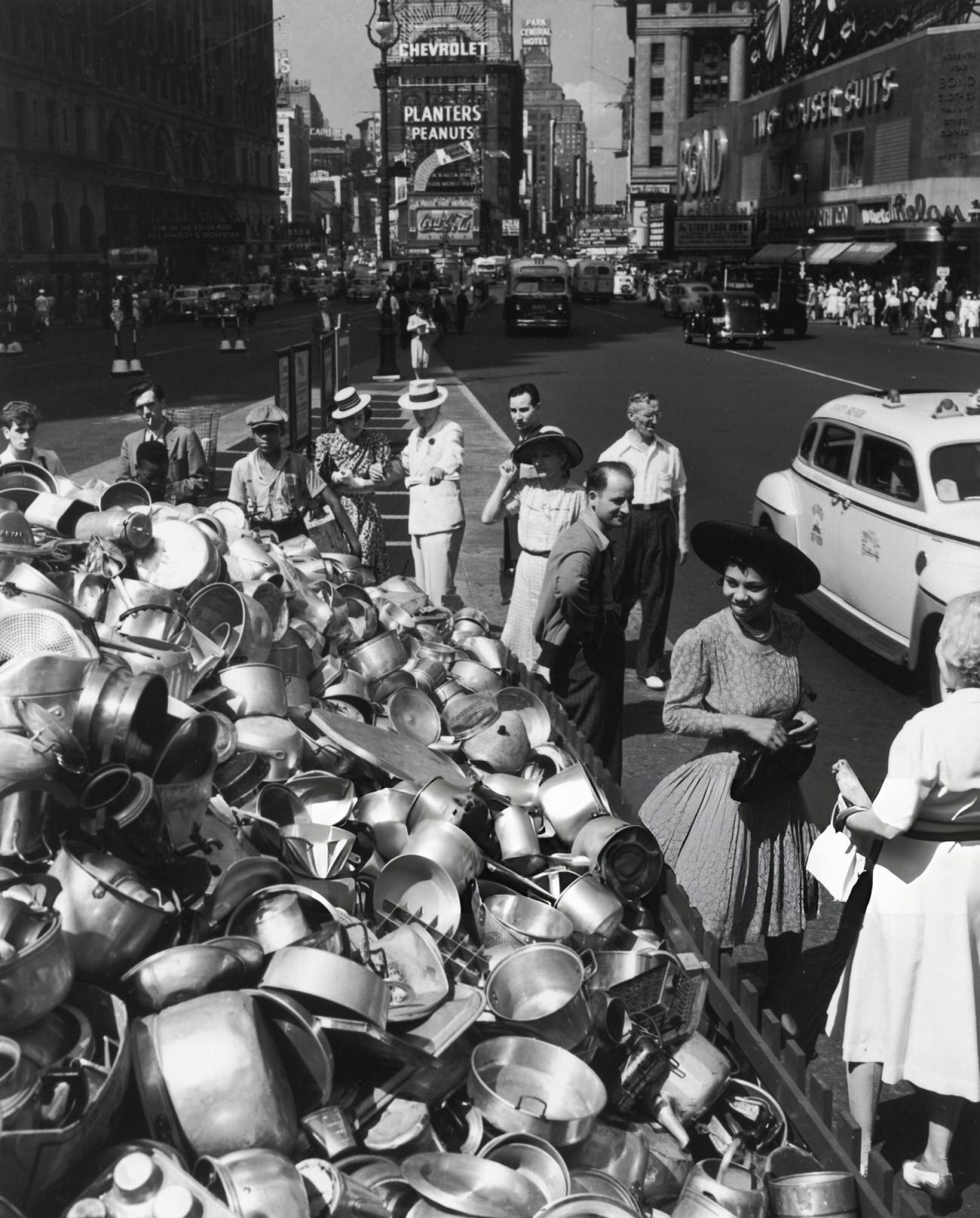 People Gathered Around A Large Heap Of Aluminum In Times Square, New York City, 1941.