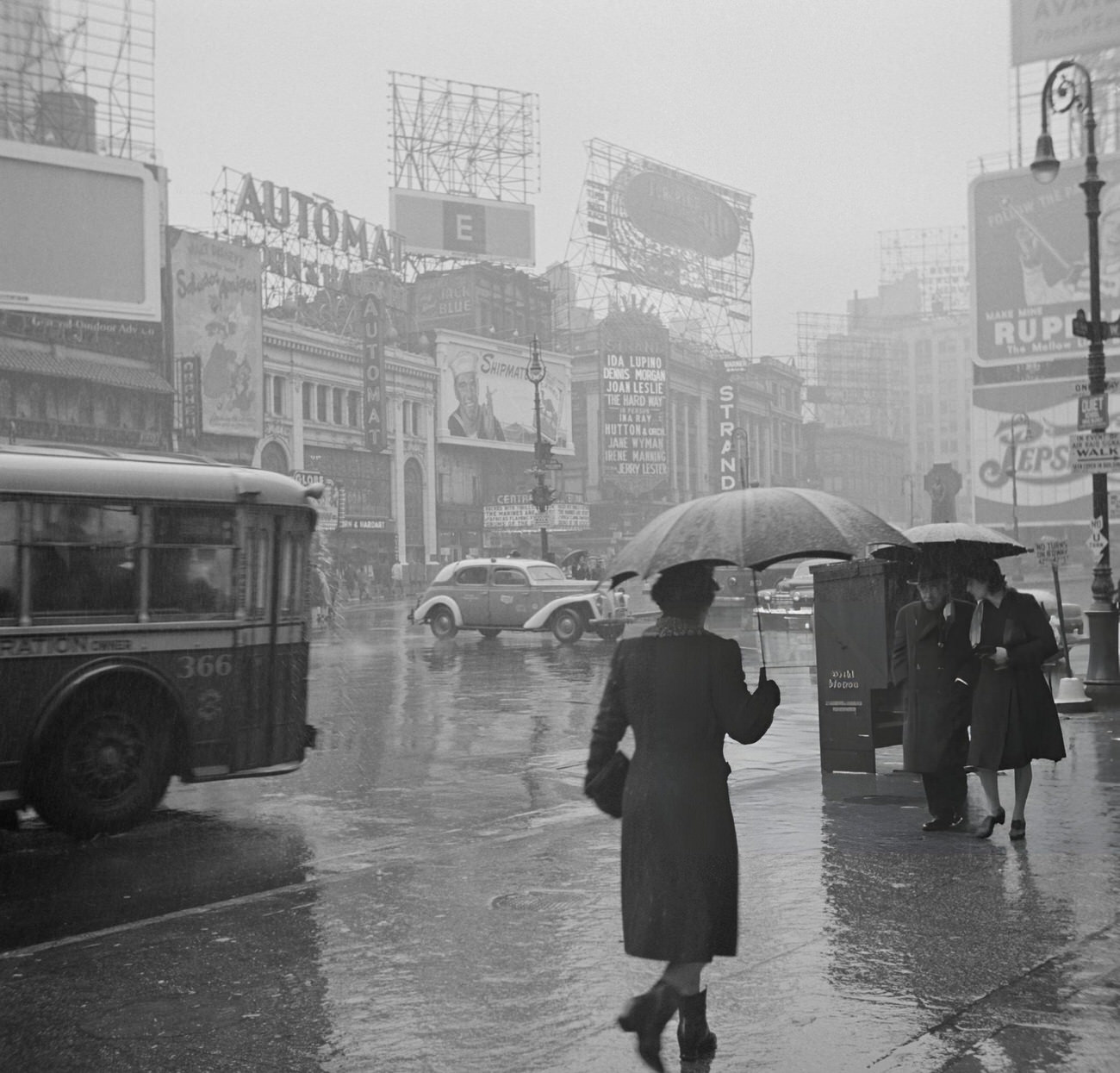 A Street Scene On A Rainy Day In Times Square, New York City, 1943.