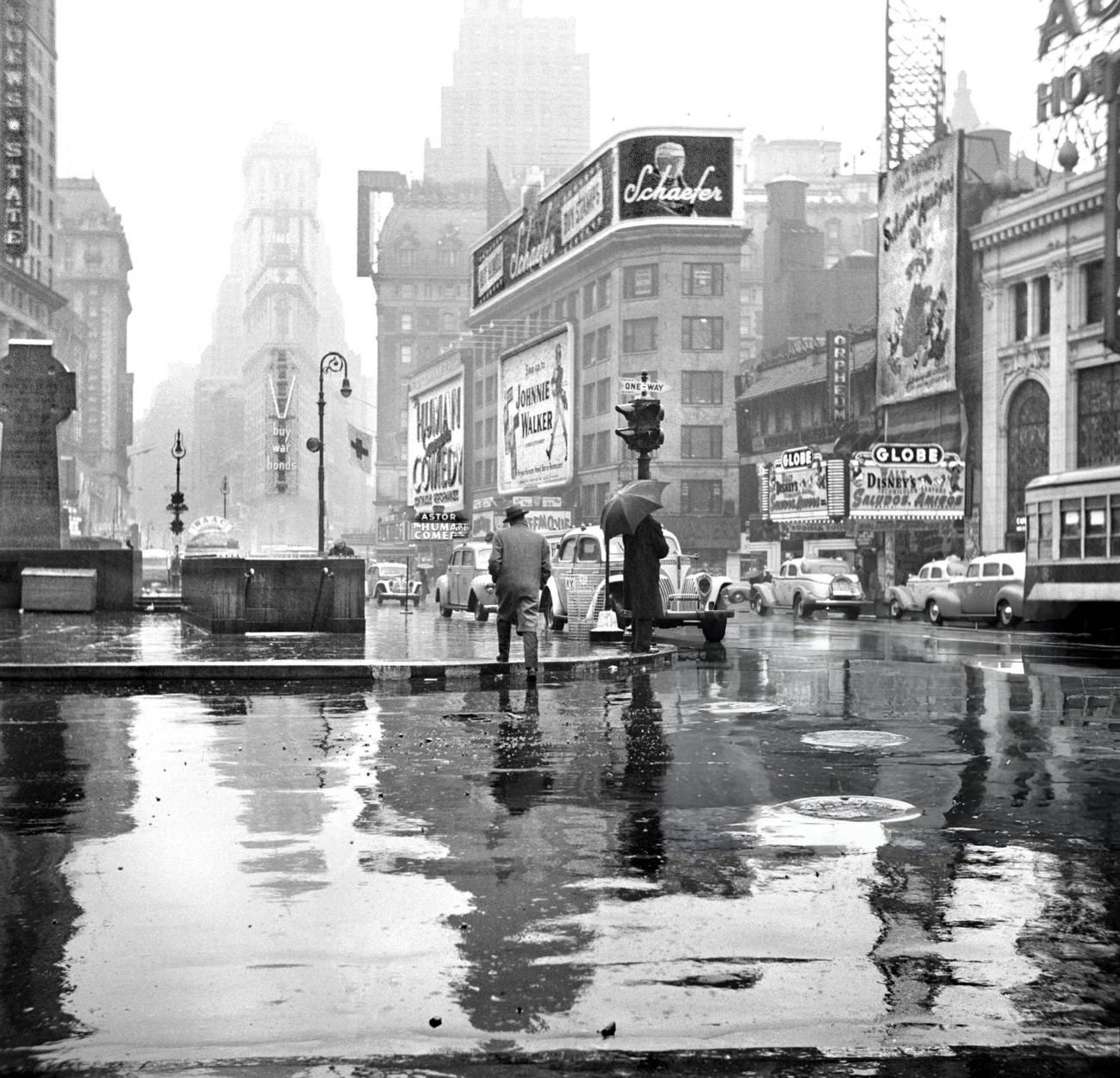 A Street Scene On A Rainy Day In Times Square, New York City, 1943.