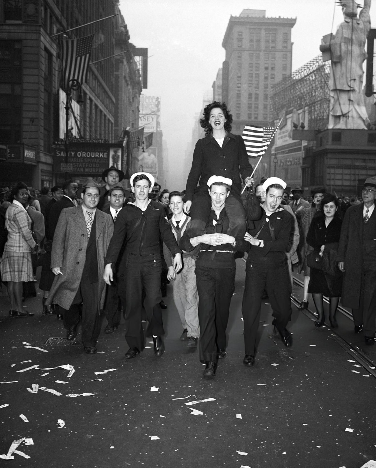 A Woman Is Carried Down A New York Street On V-E Day, 1945.