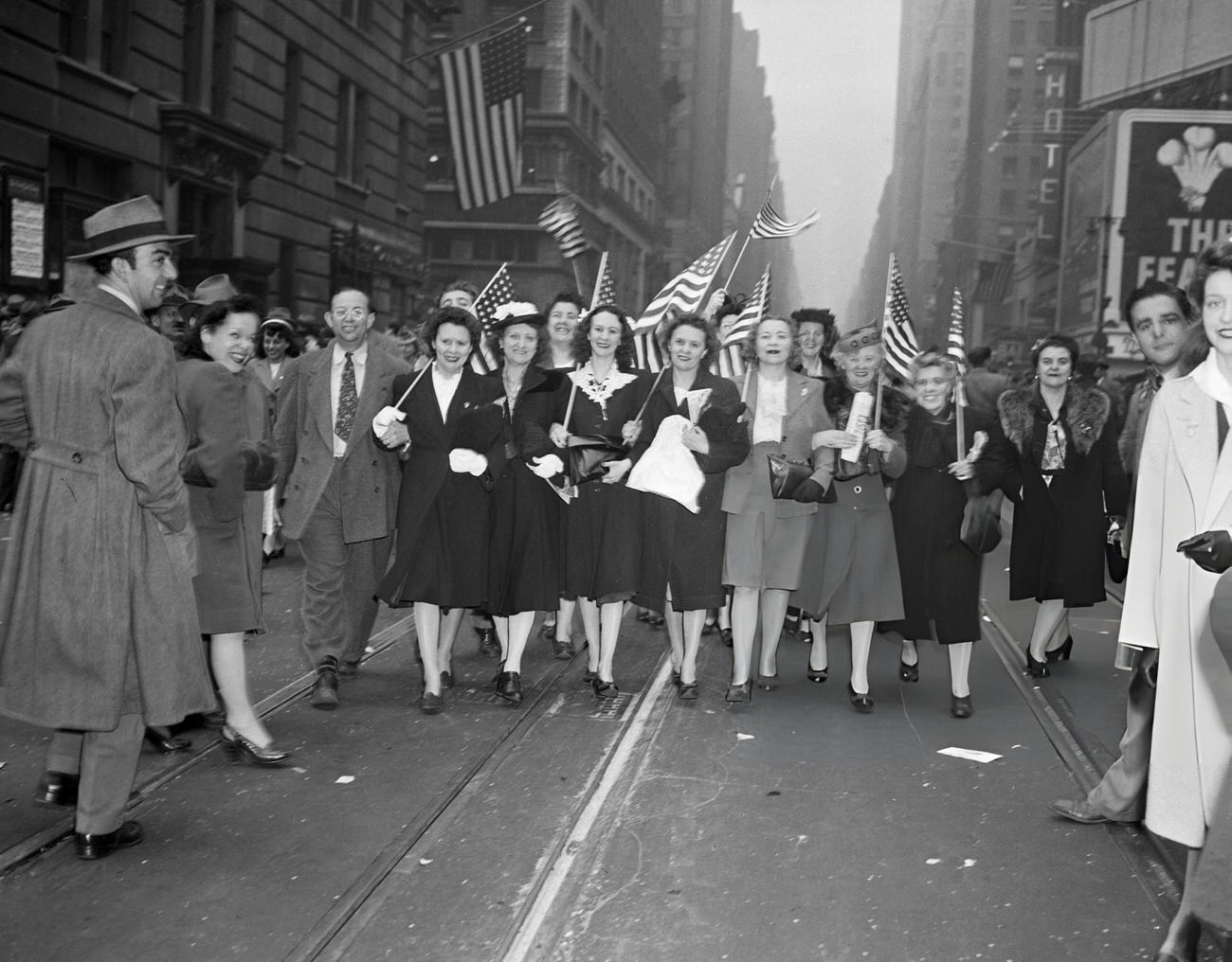 Women Carry Flags Down A Street To Celebrate V-E Day, 1945.