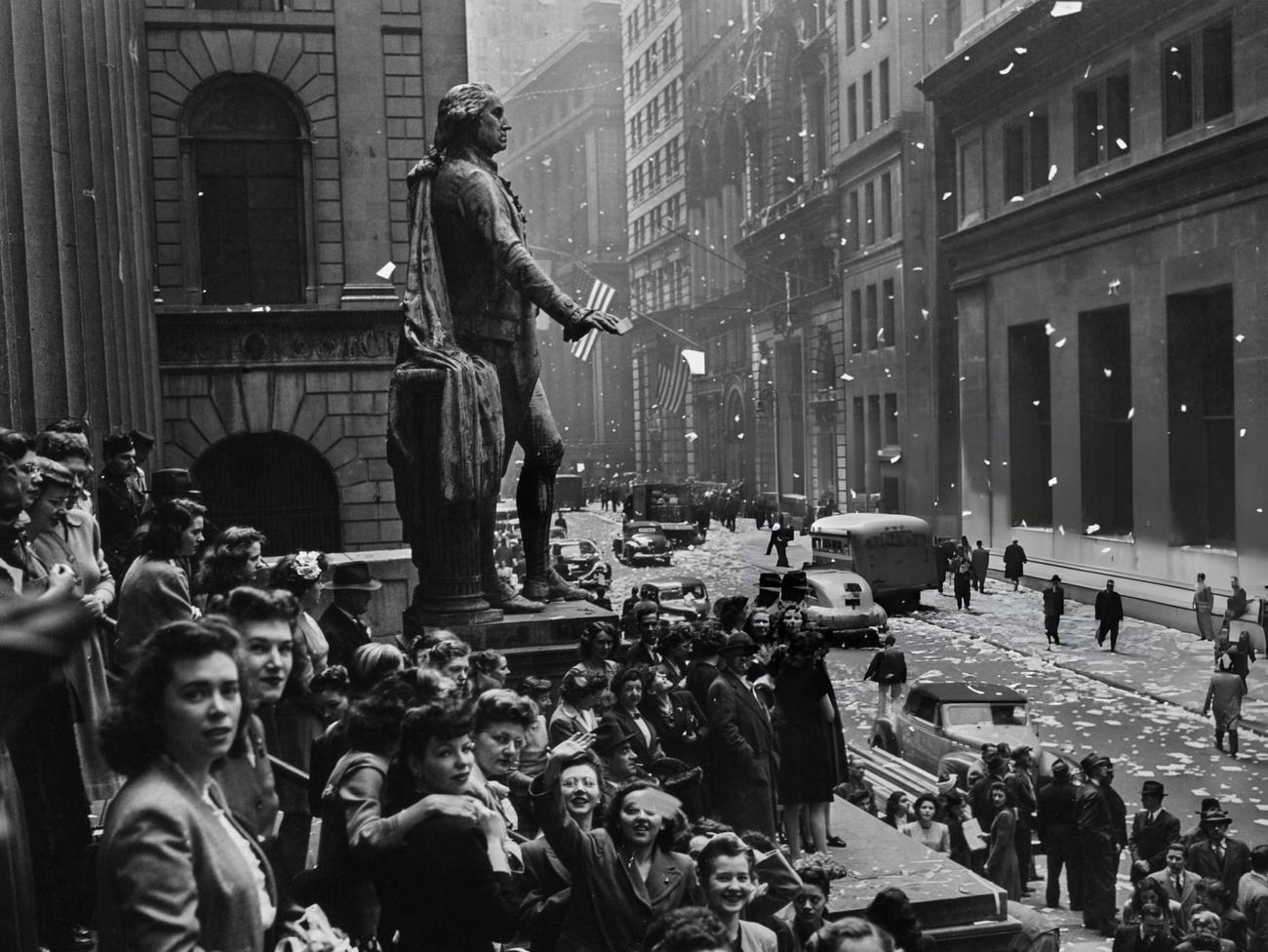 Revellers Gather Around The Statue Of George Washington, On The Steps Of The Federal Hall, On Wall Street, During The Victory In Europe Celebrations, At The End Of The Second World War, In Lower Manhattan, New York City, 1945.