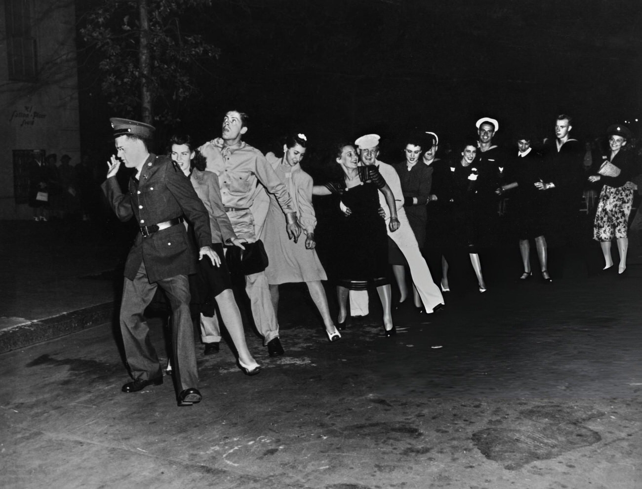 Revellers Form A Conga Line During The Victory In Europe Celebrations, At The End Of The Second World War, In The Sutton Place Neighbourhood On Manhattan'S East Side, 1945.