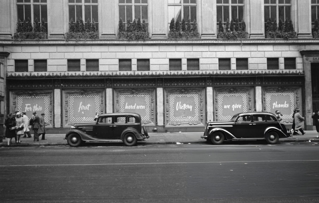 Cars Parked In Front Of The Saks Store Displaying A Set Of Posters Celebrating Ve-Day In New York City, 1945.