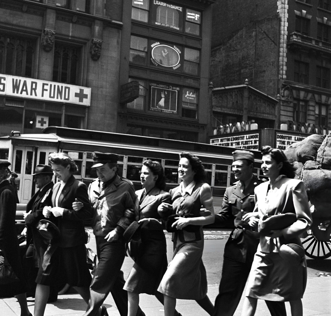 Servicemen, With A Woman On Either Arm, Make Their Way Towards Times Square For V-E Day Celebrations In New York, 1945.