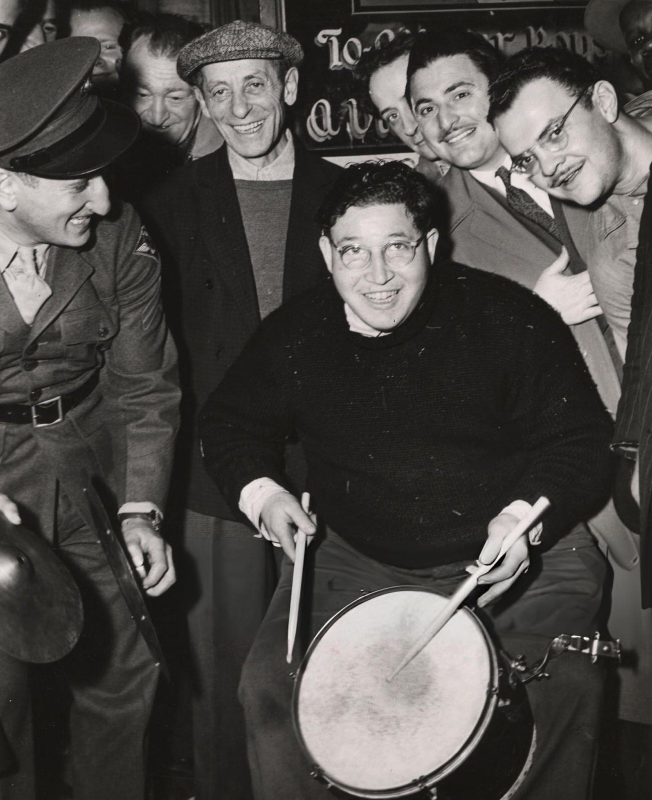 A Group Of Men, Including A Man Playing The Drums And A Man Wearing A Military Uniform Playing The Cymbals, Celebrate The End Of War In Europe, During Ve Day, 1945.