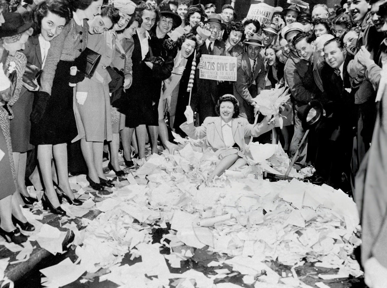 Mae Cusask Sits In A Pile Of Papers While Enjoying The Celebration Of V-E Day, 1945.