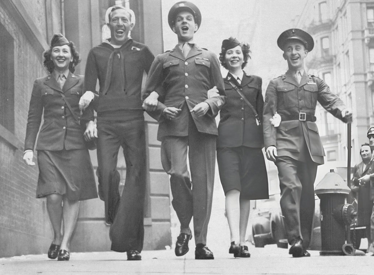 Members Of The Armed Services Stage An Impromptu Parade In Front Of City Defense Recreation Committee Headquarters During A V-E Day Celebration, 1945.