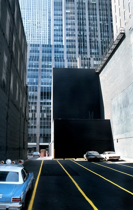 A car police in a parking lot, Mid-Manhattan, 1978.