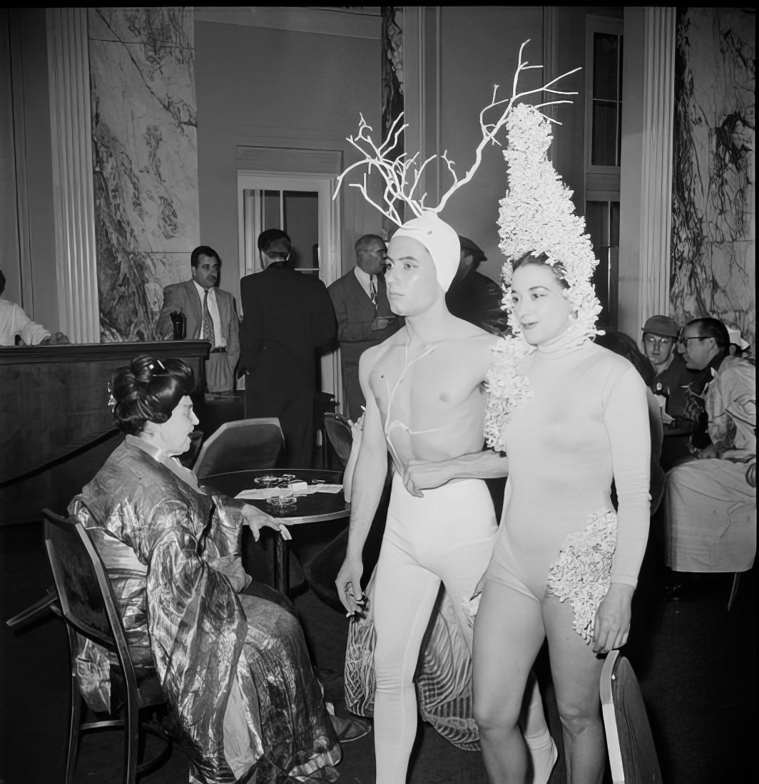 A couple wearing elaborate headpieces, 1951.