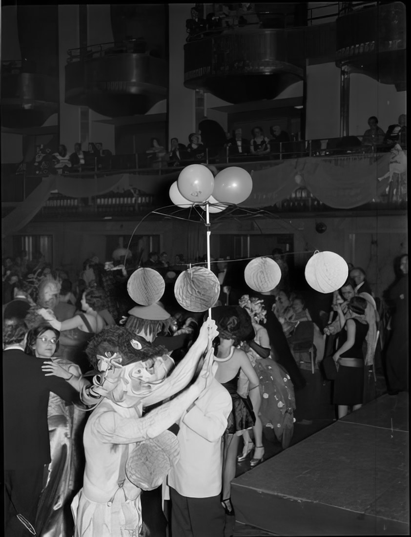 A dancing woman holding an umbrella frame decorated with balloons, 1951.