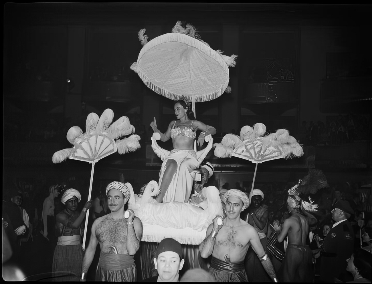 Men carrying a woman into the ball on a litter, 1951.