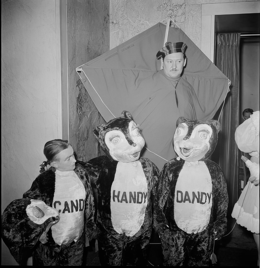 Men dressed as bears named Handy, Candy and Dandy with another man in costumes behind them, 1951.