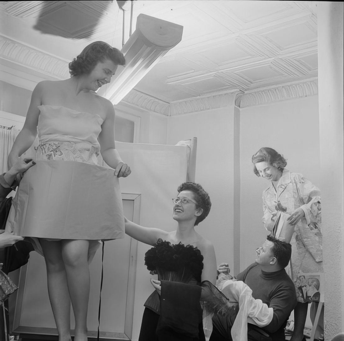 People trying on and adjusting their costumes, 1951.