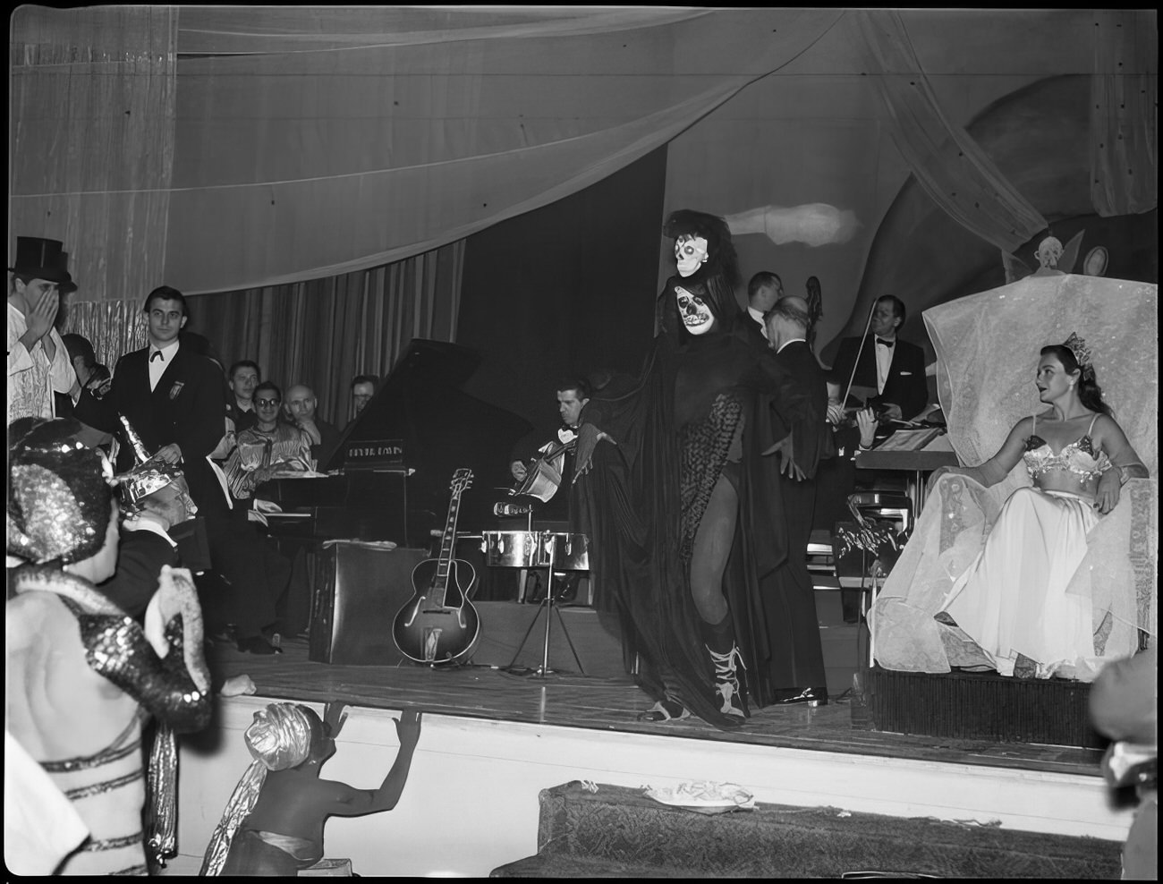 A person in costume walking across the stage, 1951.