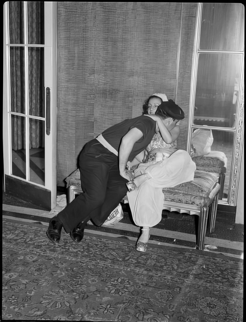 A couple kissing on a small couch, 1951.