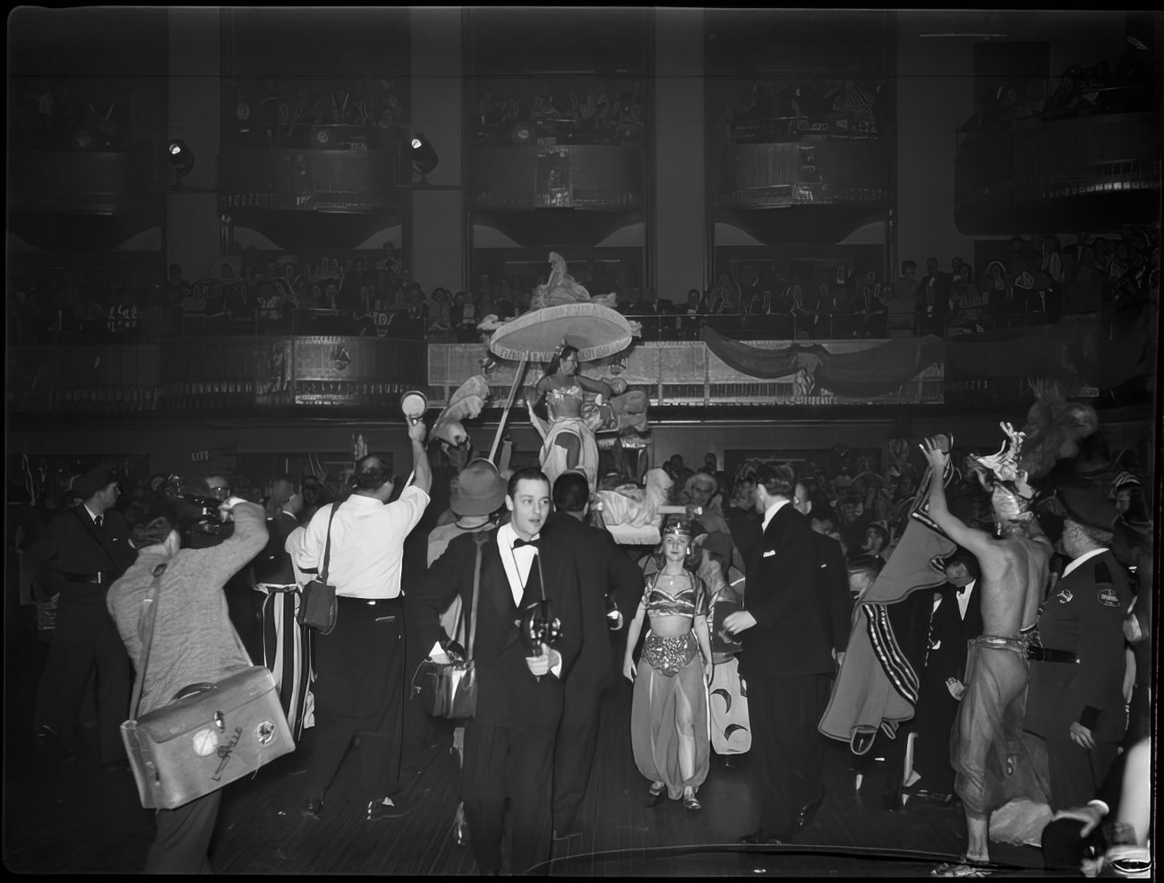 A woman entering ballroom on a litter, 1951.