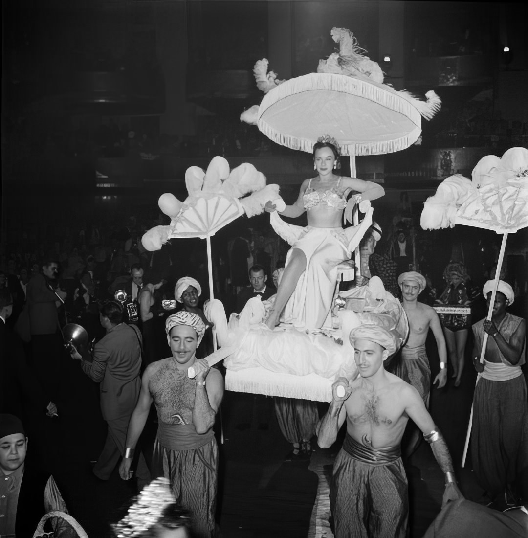 A woman entering the ball on a litter, 1951.