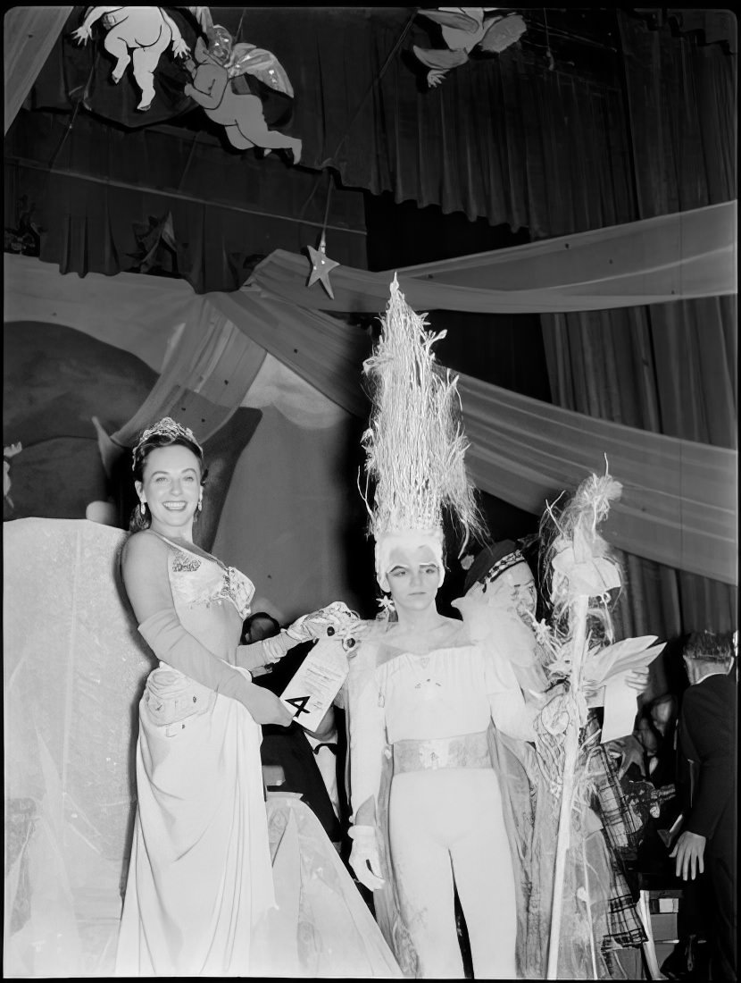 A woman giving the 4th place prize for best costume, 1951.