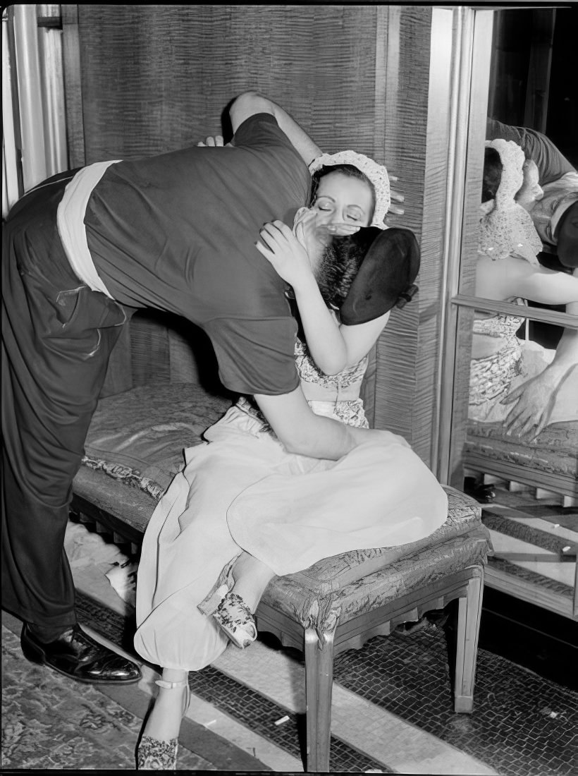 A couple kissing on a sofa, 1951.