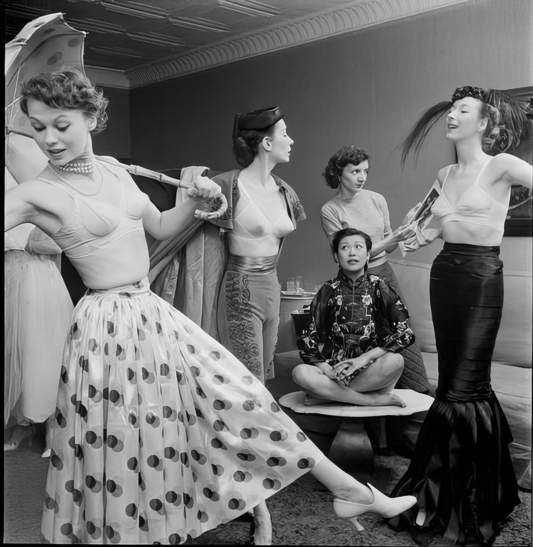 Women posing as they prepare for the ball, 1951.