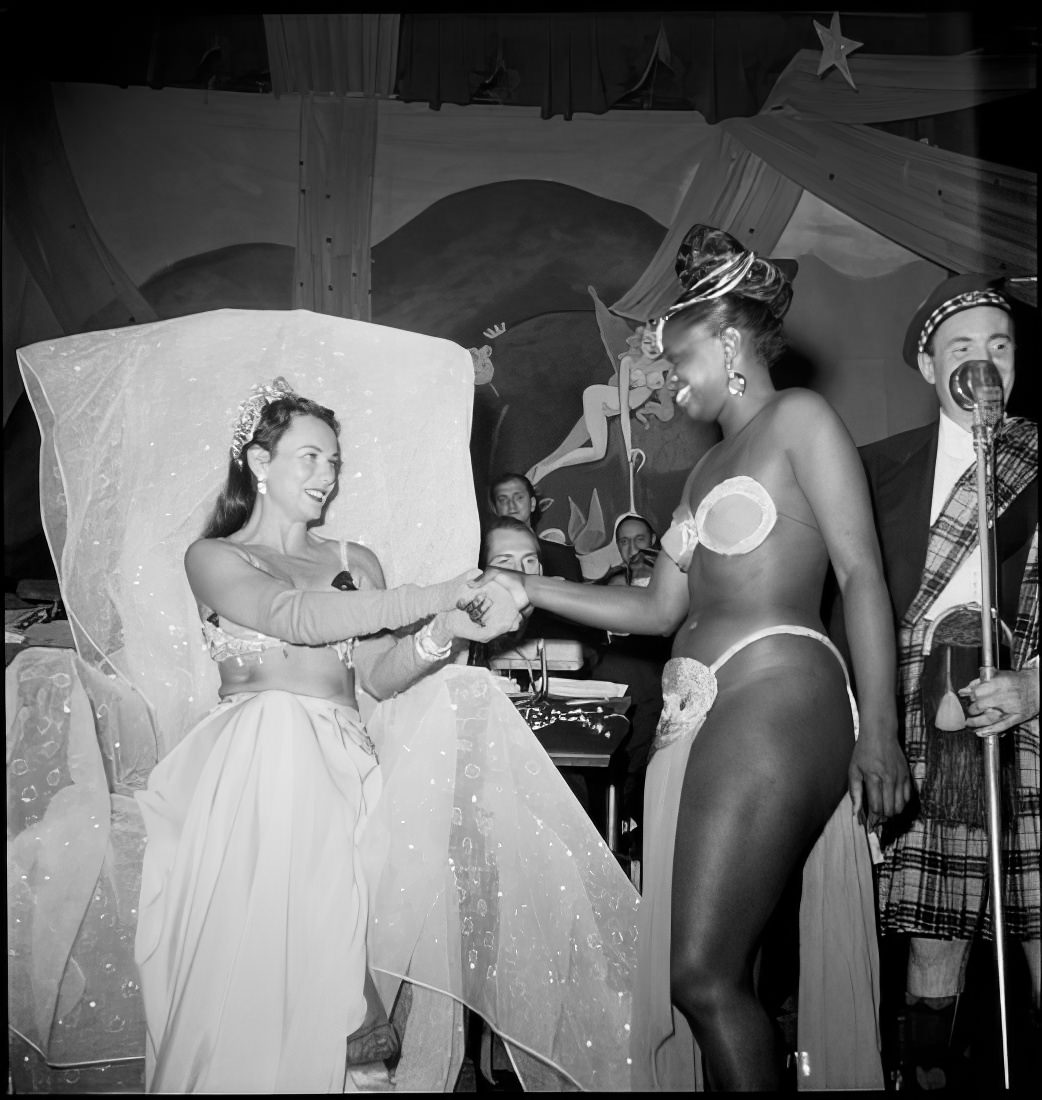 Women shaking hands on stage, 1951.