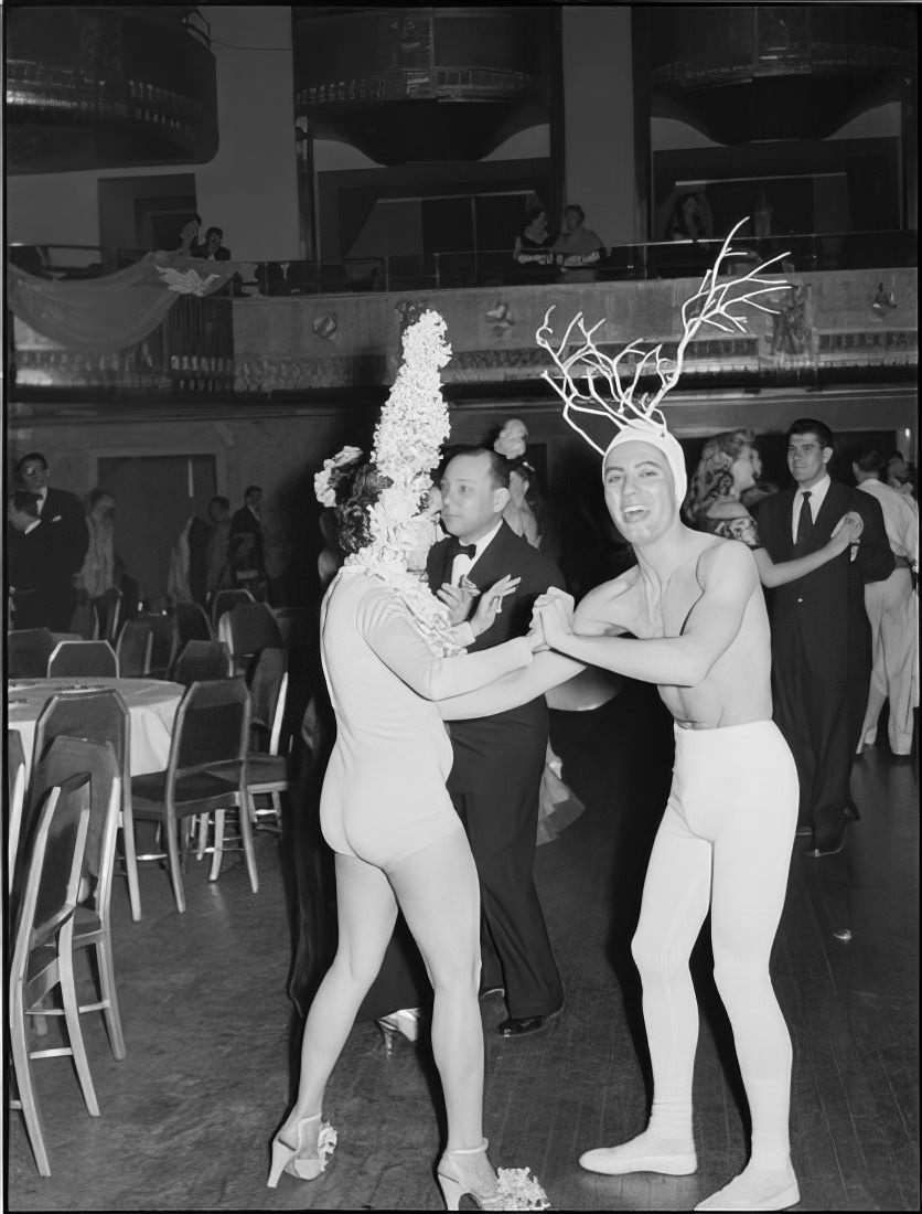 A dancing couple wearing elaborate headpieces, 1951.