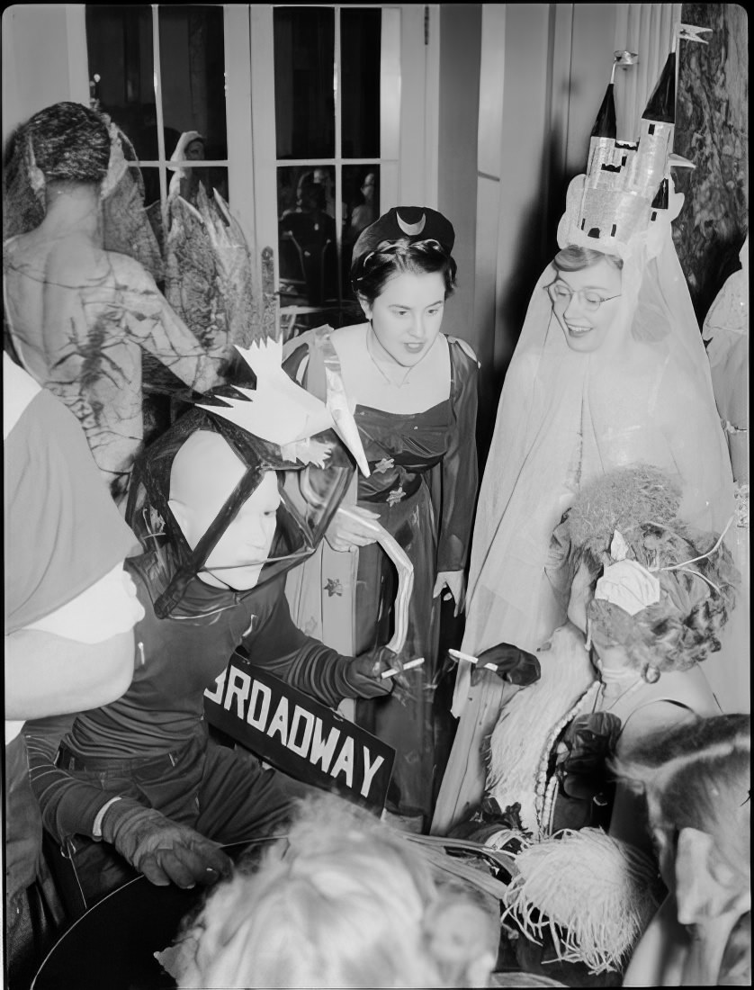 A group in elaborate costumes talking, 1951.