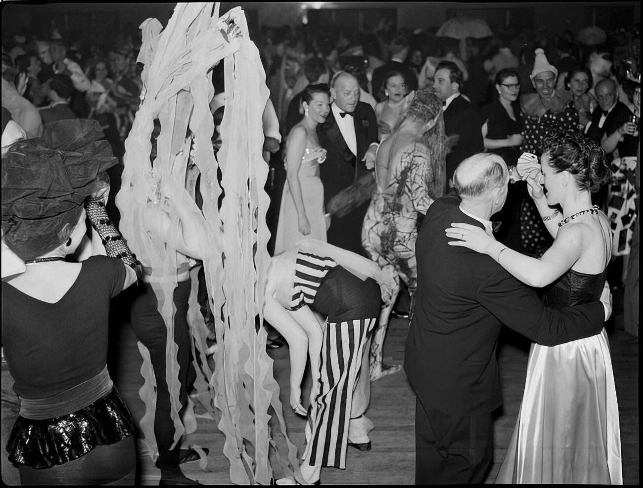 People in costume dancing at the ball, 1951.