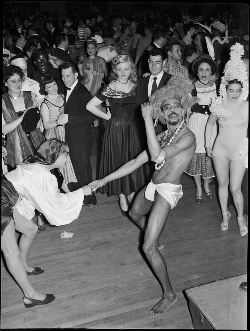 People watching a costumed couple dance, 1951.